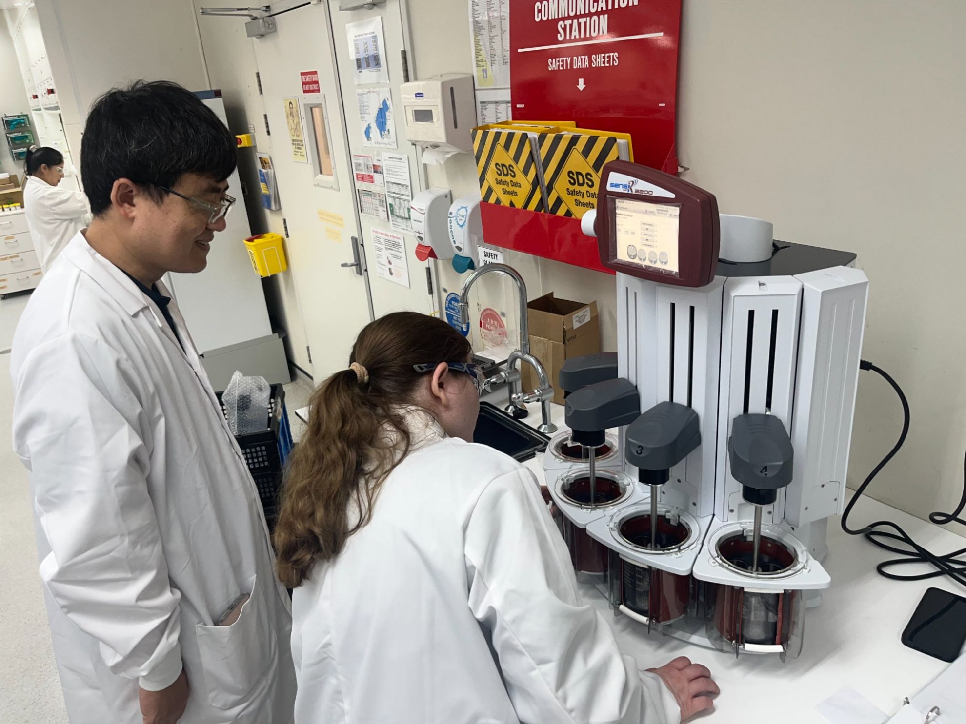 Team reviewing the Distek sensIR 3200 disintegration system in the lab