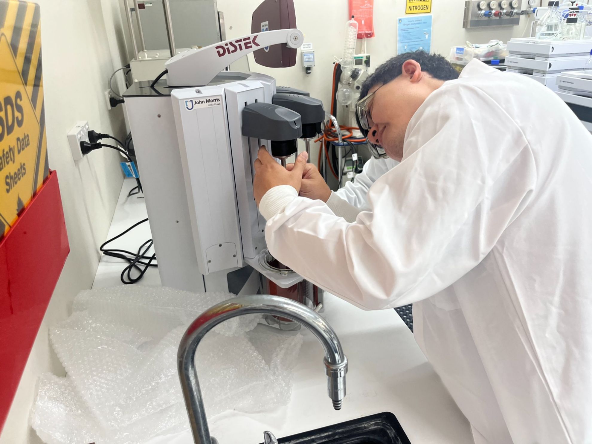 John Morris Group technician closely inspecting the Distek sensIR 3200 unit