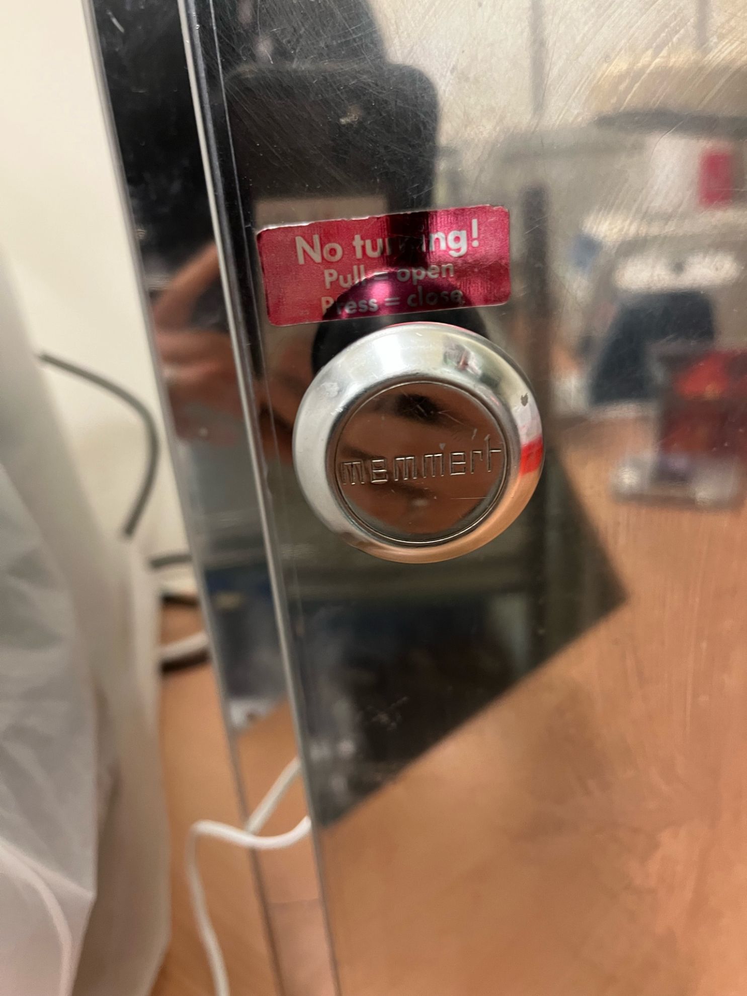 Memmert chrome door latch close-up with original branding