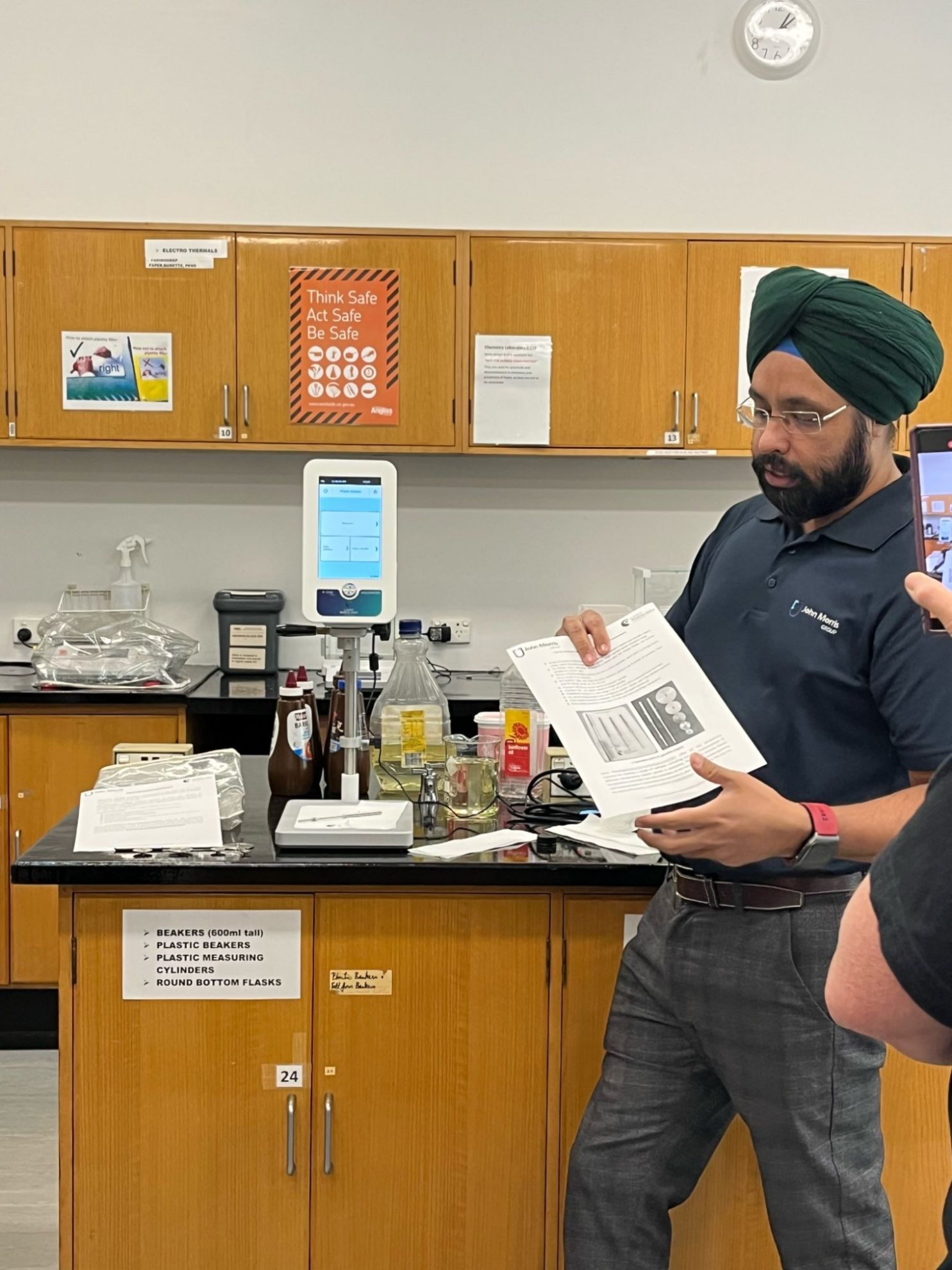 John Morris Group technical specialist presenting laboratory glassware selection guide in an Australian university lab