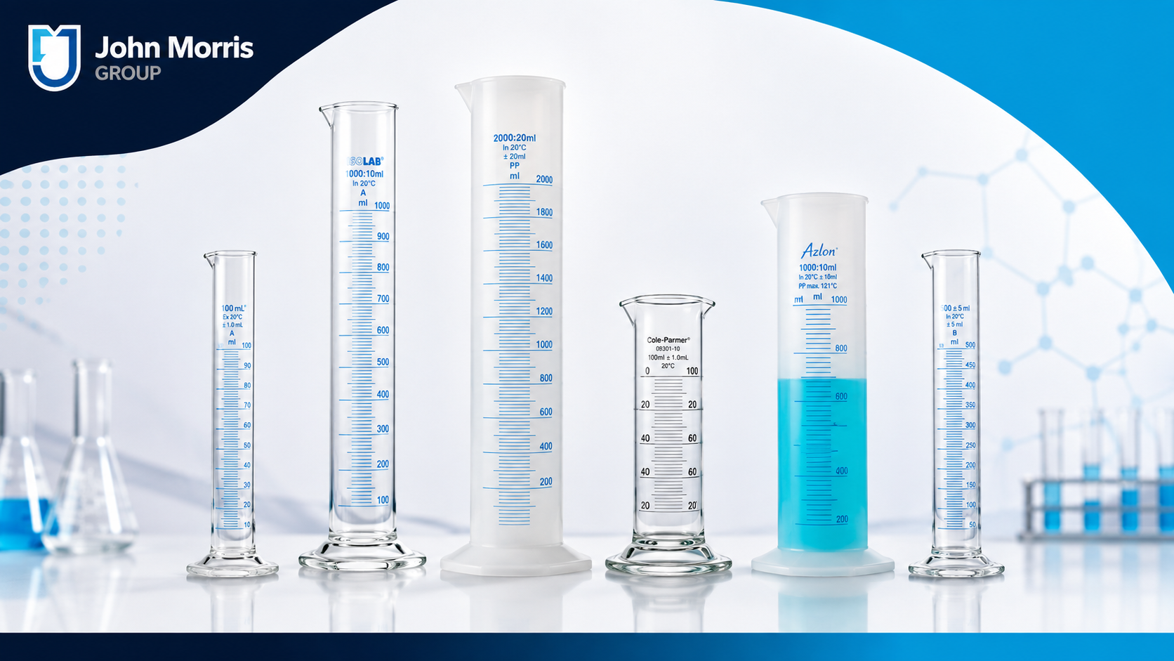 Row of glass graduated cylinders of different sizes on a laboratory bench