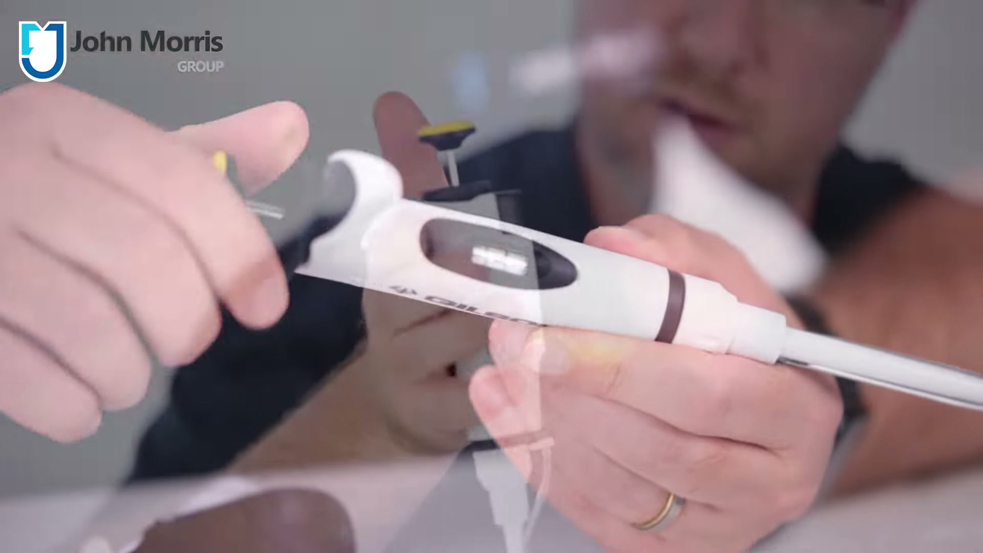 Thumb adjusting the TriLock volume-locking system on a Gilson MyPIPETMAN, still from the John Morris Group video