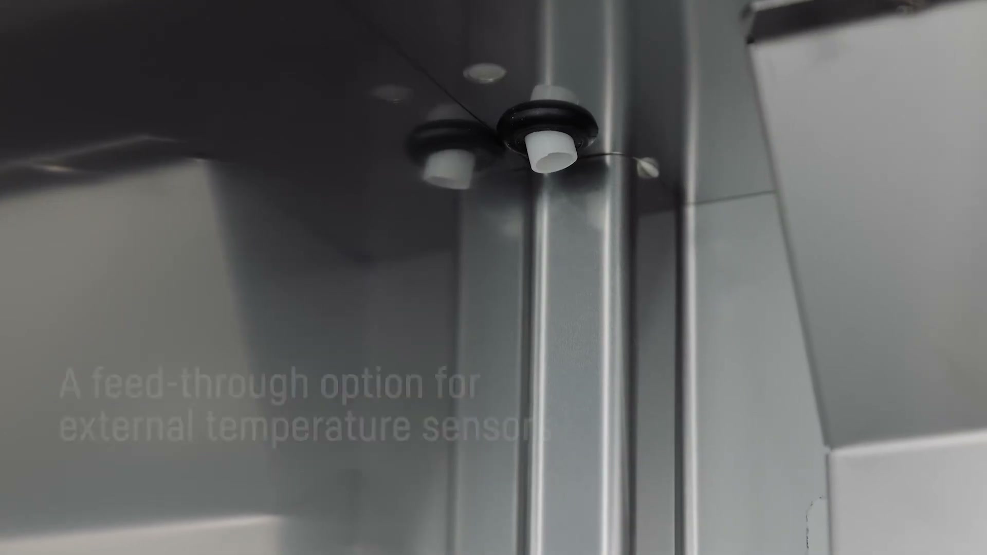 Close-up of the feed-through port on the side of a Liebherr fridge for an external temperature sensor