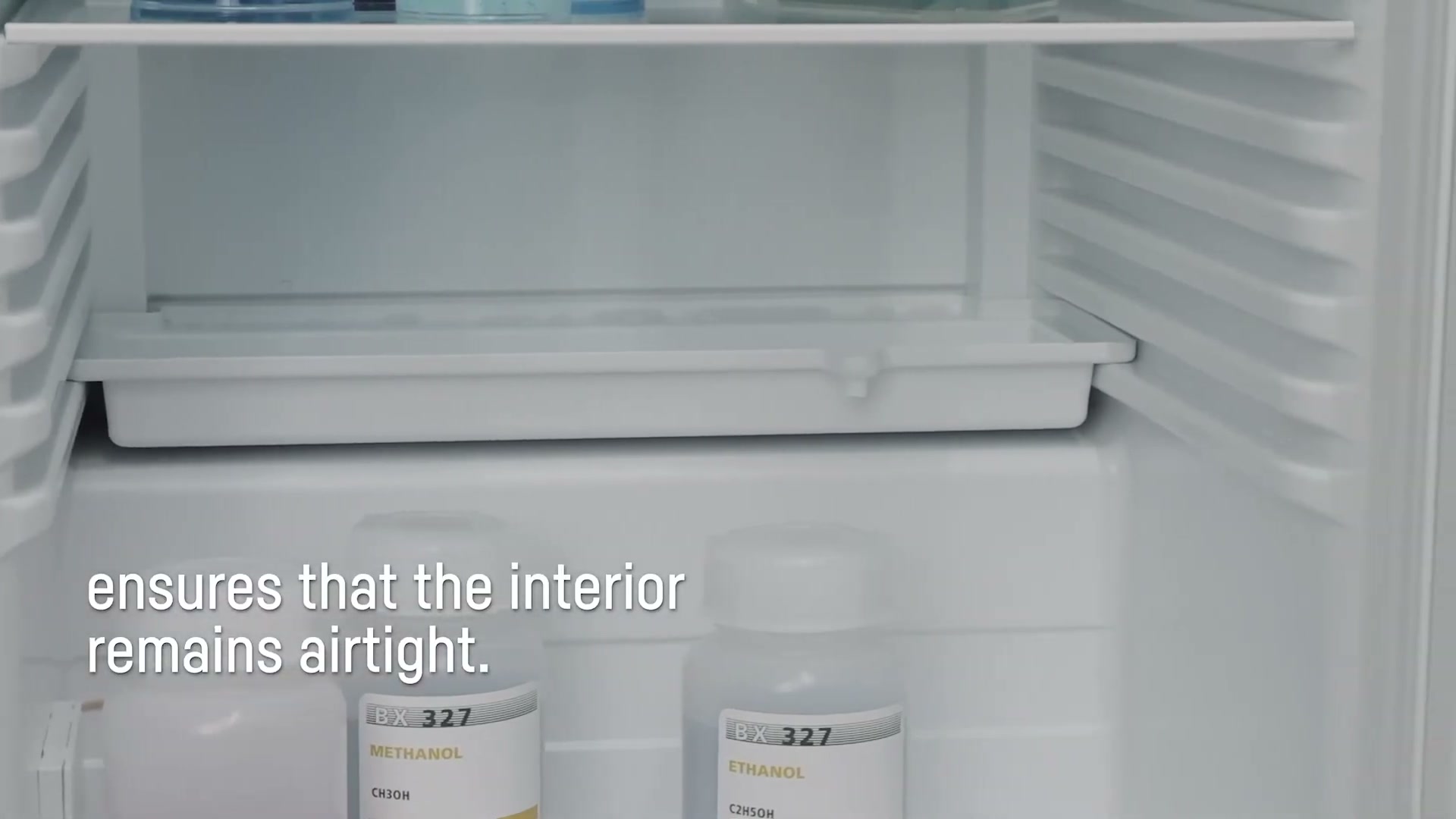 Removable defrosting tray inside a Liebherr spark-free unit with methanol and ethanol reagent bottles stored below