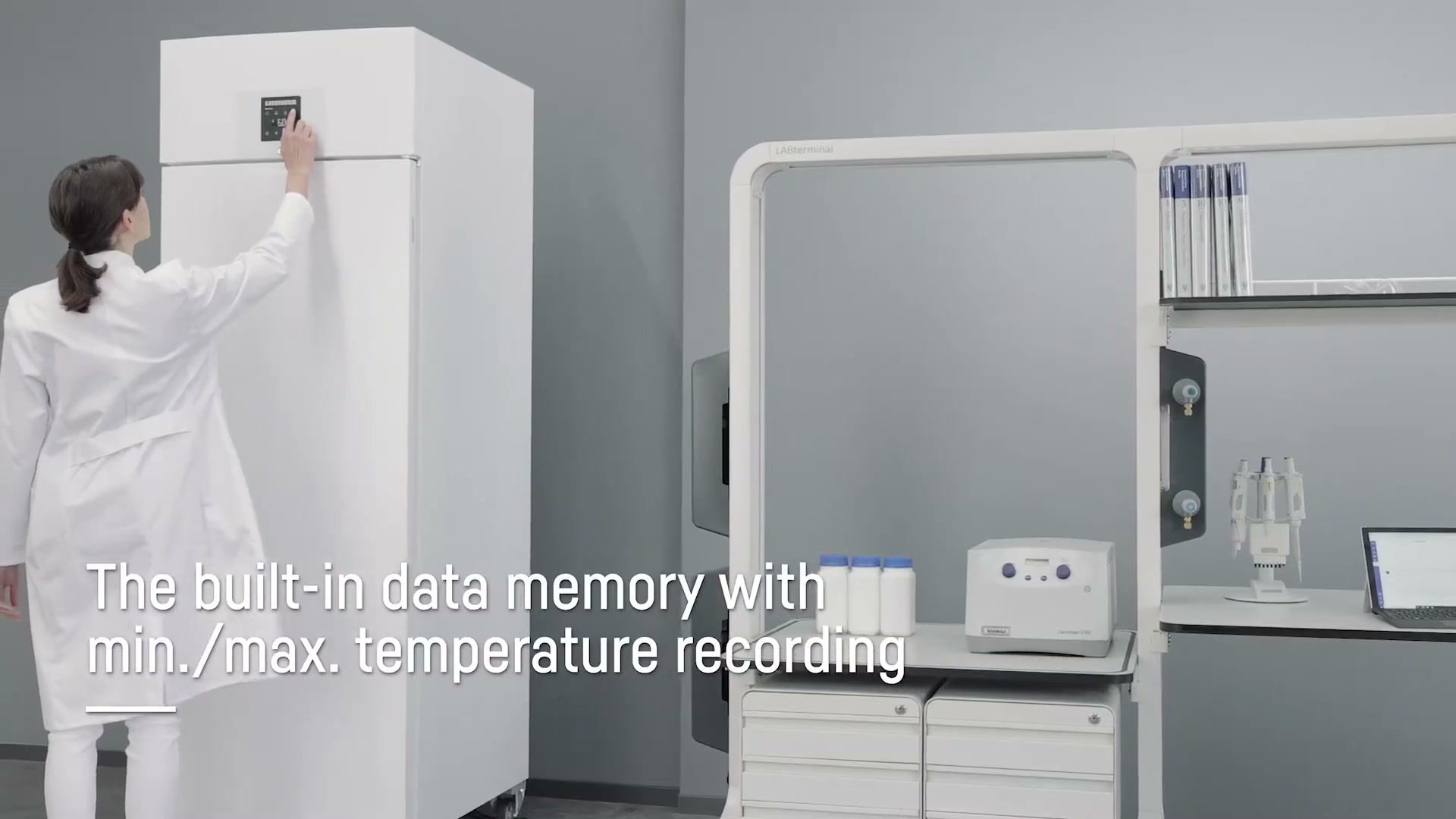 Lab technician pressing the control panel on a Liebherr fridge showing min and max temperature recording