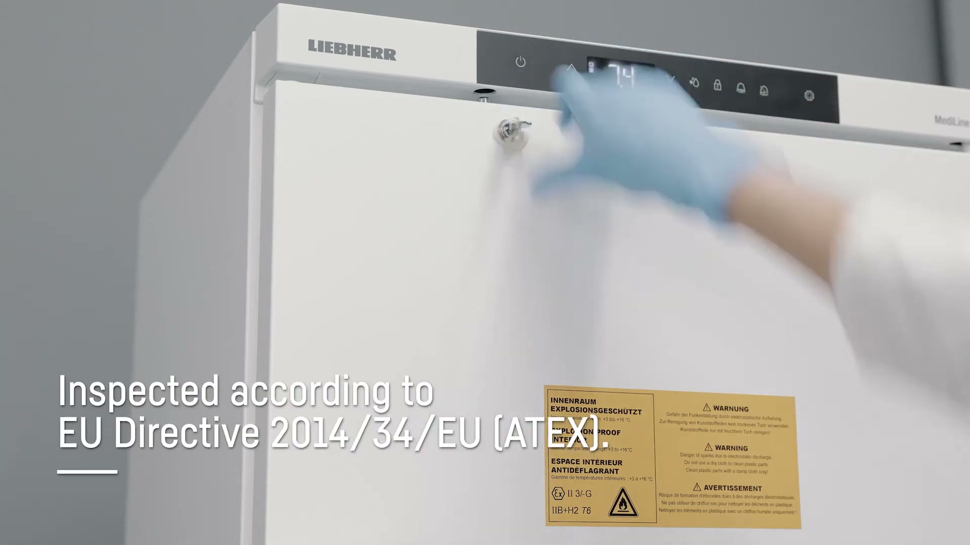 Liebherr MediLine spark-free fridge with ATEX compliance label visible and a gloved hand on the control panel